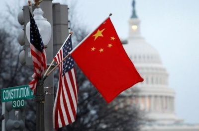 FILE PHOTO: The People's Republic of China flag and the U.S. flag fly on a lamp post along Pennsylvania Avenue near the U.S. Capitol in Washington during then-Chinese President Hu Jintao's state visit, January 18, 2011. REUTERS/Hyungwon Kang/File Photo